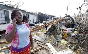 Lanada Miller stands before the remains of her trailer home being ripped apart, while leaving two other trailers with exterior damage, Saturday, Jan. 21, 2017, in Hattiesburg, Miss.