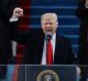 President Donald Trump pumps his fist after delivering his inaugural address.