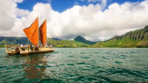 The day breaks over Hokulea with Kualoa behind her. 