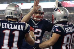 New England Patriots quarterback Tom Brady (12) celebrates with his teammates after throwing a touchdown pass to wide ...