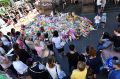 Tragic loss: The public lay flowers at Bourke street.