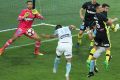 Tim Cahill heads the ball past Mariners goalkeeper Paul Izzo.