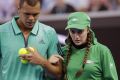 Jo-Wilfried Tsonga helps injured ballgirl Giuliana off the court at last year's Australian Open.