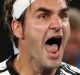 Switzerland's Roger Federer yells as he celebrates his win over Japan's Kei Nishikori during their fourth round match at ...