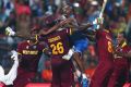 World champions: West Indies players celebrate victory after Carlos Brathwaite hit the winning runs in the final against ...
