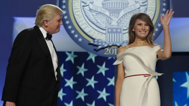 First lady Melania Trump, right, acknowledges supporters alongside President Donald Trump before dancing at the Freedom Ball.