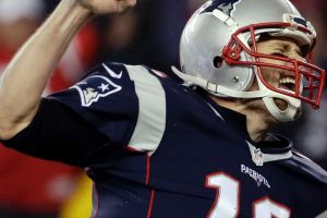 New England Patriots quarterback Tom Brady reacts after throwing a touchdown pass to Julian Edelman during the second ...