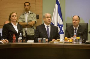 File - Israeli Prime Minister Benjamin Netanyahu, center sits with opposition leader Tzipi Livni, left, and lawmaker Tzachi Hanegbi, right , during a meeting of the foreign affairs and defense committee at the Knesset, Israel's parliament, in Jerusalem, Monday, June 1, 2009.