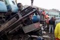 Rescuers stand around coaches of a derailed passenger train in Kuneru, Andhra Pradesh, southern India, on  January  22.