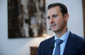 In this photo released by the Syrian official news agency SANA, shows Syrian President Bashar Assad, speaking during an interview with the Iran's Khabar TV, in Damascus, Syria, Sunday, Oct. 4, 2015.