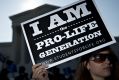 A pro-life advocate holds a sign outside the US Supreme Court before rulings in Washington, DC on June 27. 