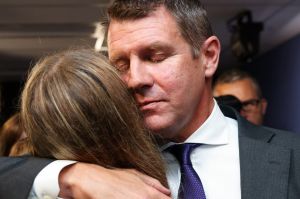 Premier Mike Baird hugs his daughter after a press conference announcing his resignation in Sydney. 