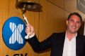 John McGrath in happier times, ringing the bell as his real estate company floated on the ASX. 