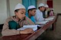 Bangladeshi Muslim students read the holy Quran at an Islamic school during Ramadan in Dhaka, Bangladesh in June 2016. 