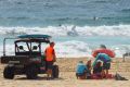 NSW Surf Lifeguards and Surf Rescue assist Tui Gallagher's mother.