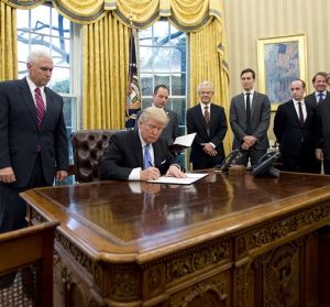 U.S. Donald Trump signs the Global Gag Order in the Oval Office. 