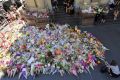 The public lay flowers at Bourke Street after five people died.