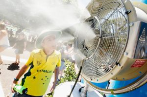 Children cool off under misting fans during day 1 of the Australian Open.