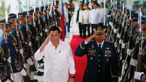 Asian affairs: Philippine President Rodrigo Duterte salutes the honour guard prior to his departure for Cambodia and ...