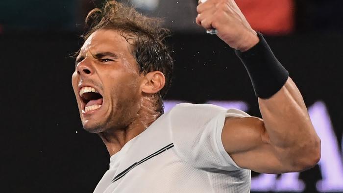 TOPSHOT - Spain's Rafael Nadal celebrates his victory against France's Gael Monfils during their men's singles fourth round match on day eight of the Australian Open tennis tournament in Melbourne on January 23, 2017. / AFP PHOTO / SAEED KHAN / IMAGE RESTRICTED TO EDITORIAL USE - STRICTLY NO COMMERCIAL USE