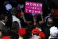 An attendee holds a "Women For Trump" sign during an election night party for U.S. President-elect Donald Trump at the ...