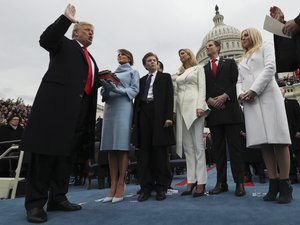 U.S. President Donald Trump takes the oath of office as his wife Melania holds the Bible and his children Barron, Ivanka, Eric and Tiffany watch as U.S. Supreme Court Chief Justice John Roberts (R) administers the oath during inauguration ceremonies swearing in Trump as the 45th president of the United States on the West front of the U.S. Capitol in Washington, DC, U.S., January 20, 2017.