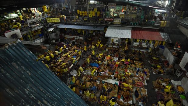 Some of the 3562 inmates sleep on any available space on the basketball court in jail in Manila, Philippines. The ...