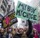 Demonstrators hold signs while marching towards Trump Tower during the Women's March in New York, U.S., on Saturday, ...