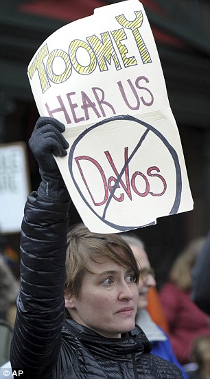 Emily Kane, from Highland Park, shows disapproval of the nomination of Betsy DeVos as Secretary of Education during a 'Tuesdays with Toomey' gathering to protest her nomination in front of Senator Pat Toomey's office