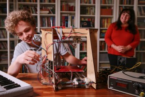 Gerardine Hansen with her son Hansen and the 3D printer he built. 
