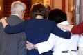NSW Premier Gladys Berejiklian embaces her parents and sisters at Government House after being sworn in by Governor ...