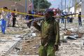 A Somali soldier patrols the area of a suicide car bomb attack in Mogadishu on January 2. The city is frequently ...