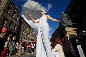 Fringe performers promote their shows on Edinburgh's Royal Mile.