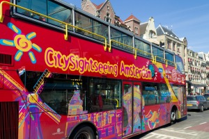 An Amsterdam sightseeing tourist bus with a panoramic roof offers tourists a hop-on, hop-off service at 12 points of ...