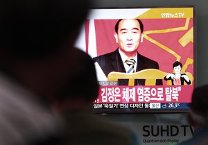 People watch a TV news showing a file image of Thae Yong Ho, minister at the North Korean Embassy in London, at Seoul Railway Station in Seoul, South Korea, Wednesday, Aug. 17, 2016.