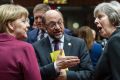 German Chancellor Angela Merkel, left, speaks with British Prime Minister Theresa May, right, and then-European ...