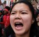 A coalition of students, immigrants, refugees and supporters fill a downtown street as they head to a rally in Seattle ...