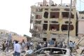 A crowd gathers at a hotel heavily damaged by a car bomb blast in Mogadishu, Somalia.