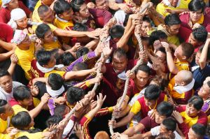 Filipino Roman Catholic devotees pull ropes that serve as a guide for the carriage of the Black Nazarene during a ...