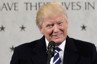 US President Donald Trump smiles while speaking at the CIA Headquarters in Langley, Virginia, on Saturday, January 21, 2017. 