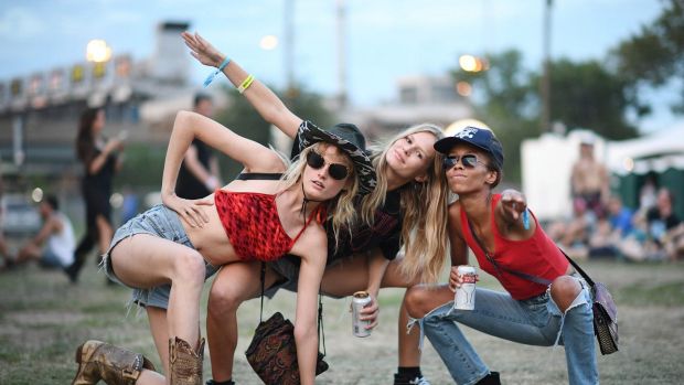 (L-R) Model Hanne Gaby Odiele wearing denim shorts, a cowboy hat and cowboy boots poses with Anna Ewers and guest at the ...