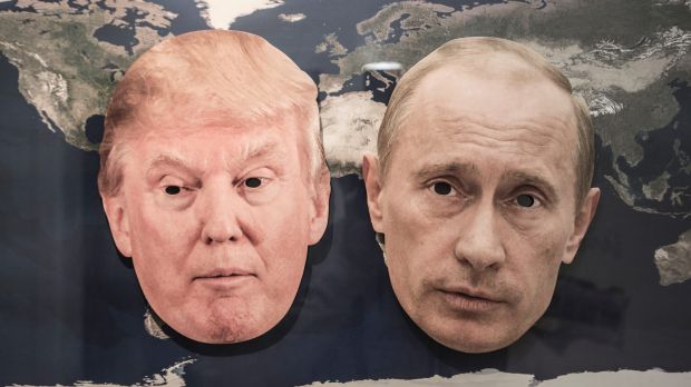 The masks of Donald Trump and the Russian President Vladimir Putin on a world map.
