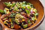 Grilled sweetcorn salad with black beans and pickled onion.