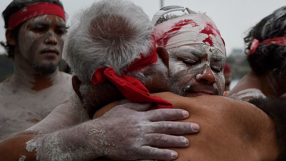 The Koomurri East Coast Sunrise ceremony people embrace Uncle Max (2nd from left) after the WugulOra Australia Day ...