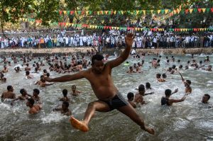 An Ethiopian Orthodox worshipper jumps into Fasilides Bath during the annual Timkat epiphany celebration in Gondar, ...