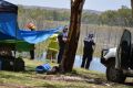 Police and QFES workers begin the search for nine-year-old Tobi Parkes after a jet ski accident at Lake Moondarra, in ...