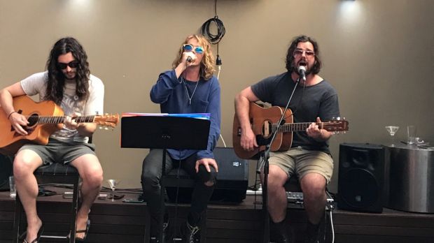 Local band members Pat, Sam and Alex play in the outdoor courtyard of the Harold Park Hotel in Glebe.