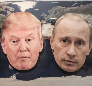 The masks of Donald Trump and the Russian President Vladimir Putin on a world map.