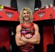 Boots 'n' all: there's no hiding Dyson Heppell's delight at being back in the Bombers locker room.