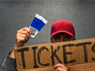 Shady character scalping a pair of concert tickets